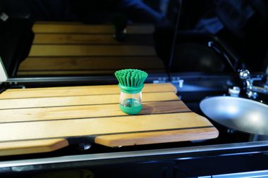 Brosse à vaisselle peu encombrante avec distributeur de produit vaisselle intégré astucieux